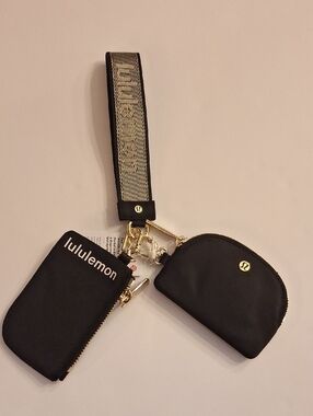 NWT Lululemon Dual Pouch Wristlet Wordmark Blk/gold